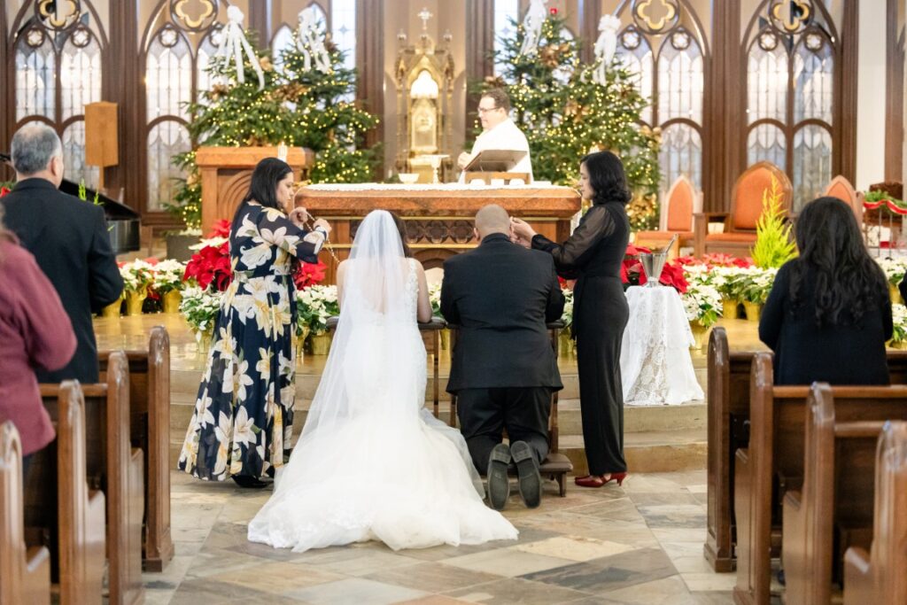 Catholic Bride and Groom have the lazo placed over their shoulders.